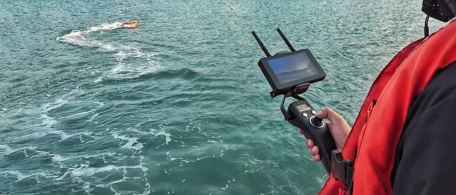 Dolphin 3 handheld controller with its display, driving the unit out to a swimmer